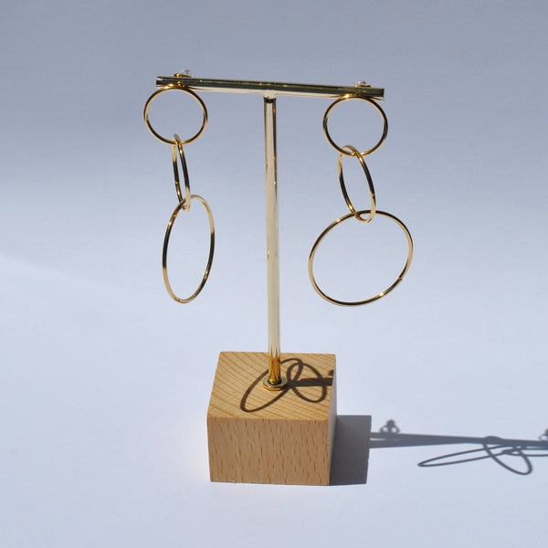 Gold fashion earrings featuring oversized open hoops and trendy modern statement jewelry aesthetic.