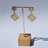 Luxury gold filigree drop earrings with floral clover design and elegant statement jewelry styling for women.