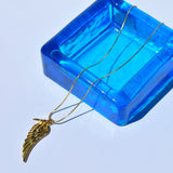 Women’s trendy wing pendant necklace featuring sleek gold finish and delicate minimalist chain design.