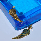 Fashion gold wing earrings with intricate feather detailing for edgy bohemian and contemporary jewelry styling.