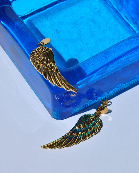 Fashion gold wing earrings with intricate feather detailing for edgy bohemian and contemporary jewelry styling.