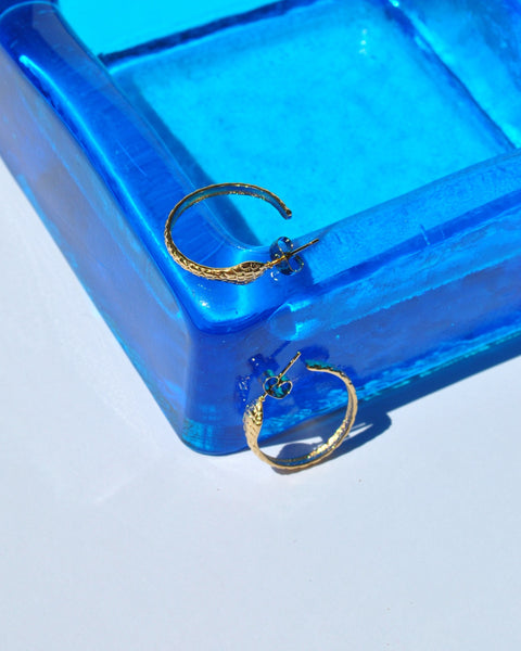 Modern women’s gold hoop jewelry with organic snake shaped embossed finish and polished luxe appearance for chic outfits.