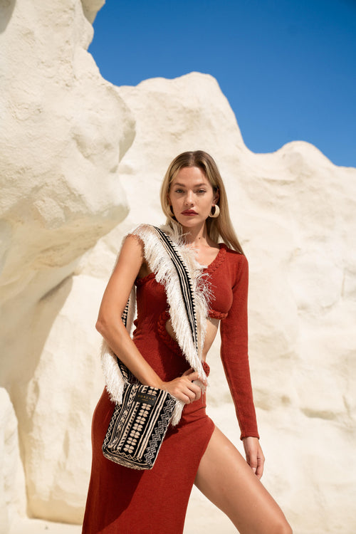 Women’s woven fringe handbag featuring geometric ethnic-inspired print and luxe bohemian vacation aesthetic.