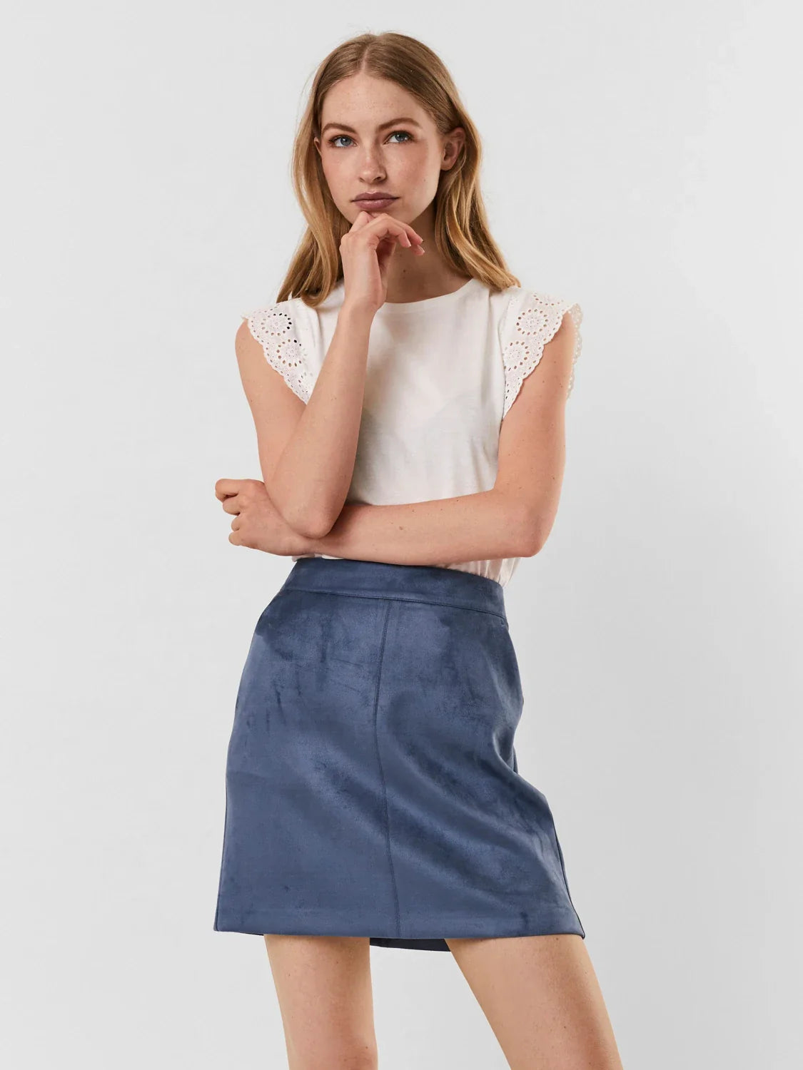White minimalist top featuring broderie anglaise trim and timeless appeal.