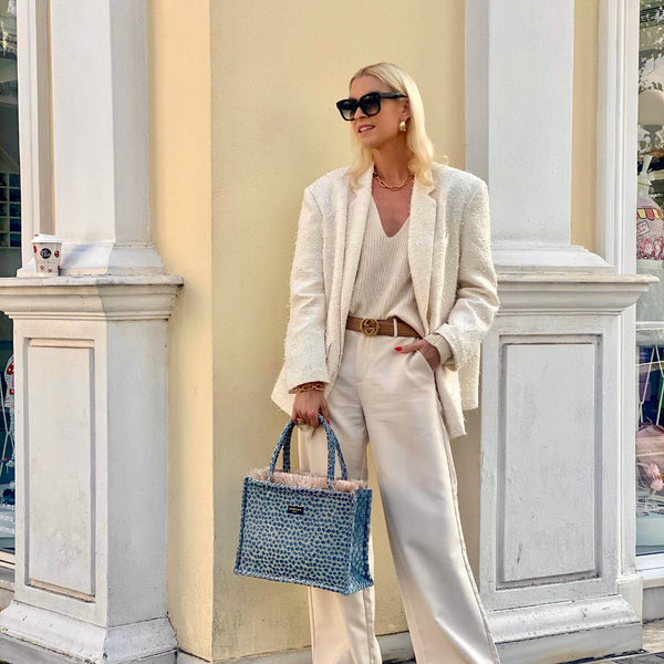 Trendy boutique tote bag with structured top handles, tactile woven texture, and modern coastal elegance.