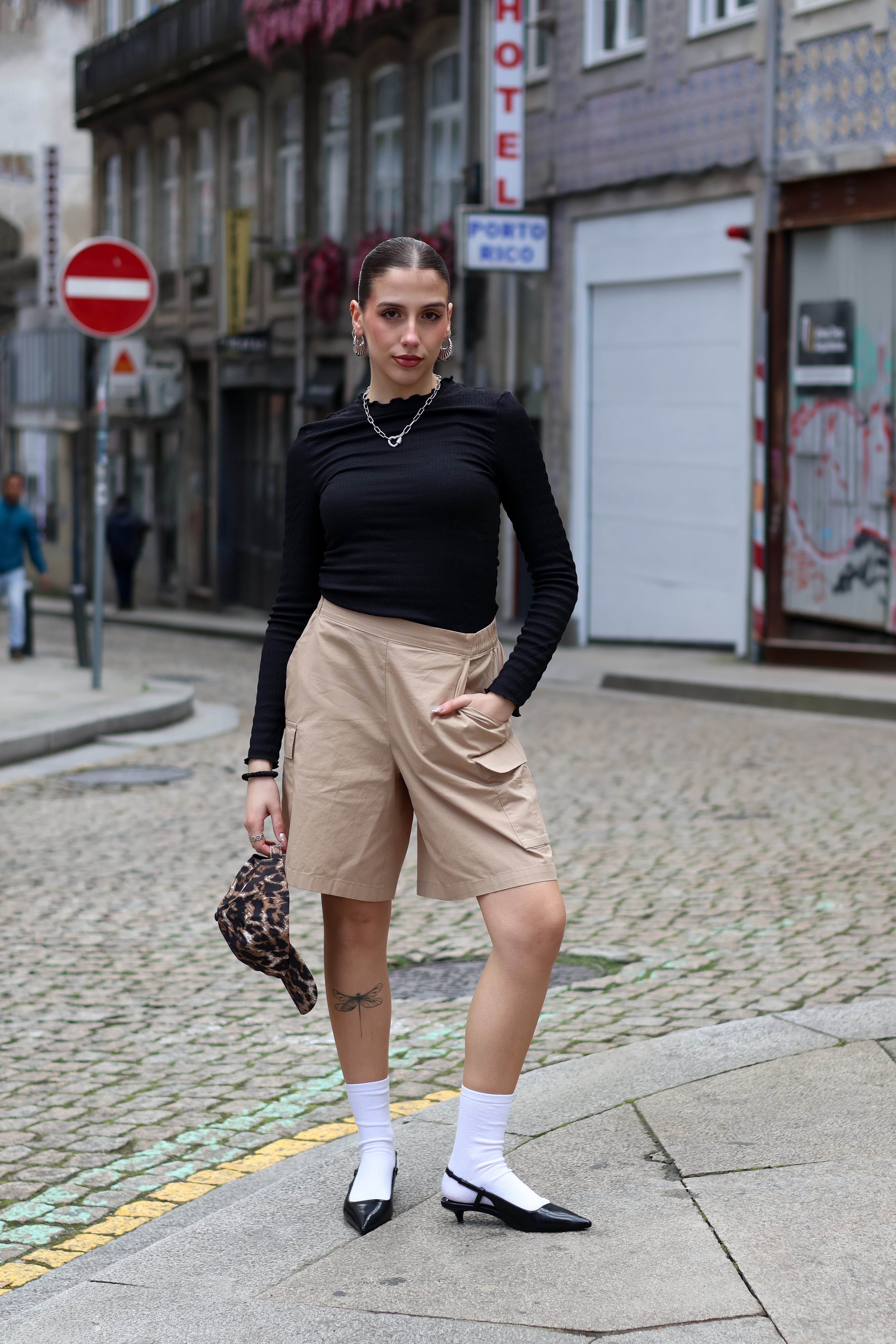 Women’s modern cargo Bermuda shorts paired with chunky loafers for edgy contemporary streetwear style.