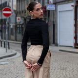 Women’s high-waisted cargo shorts with sleek utility styling and versatile capsule wardrobe aesthetic.
