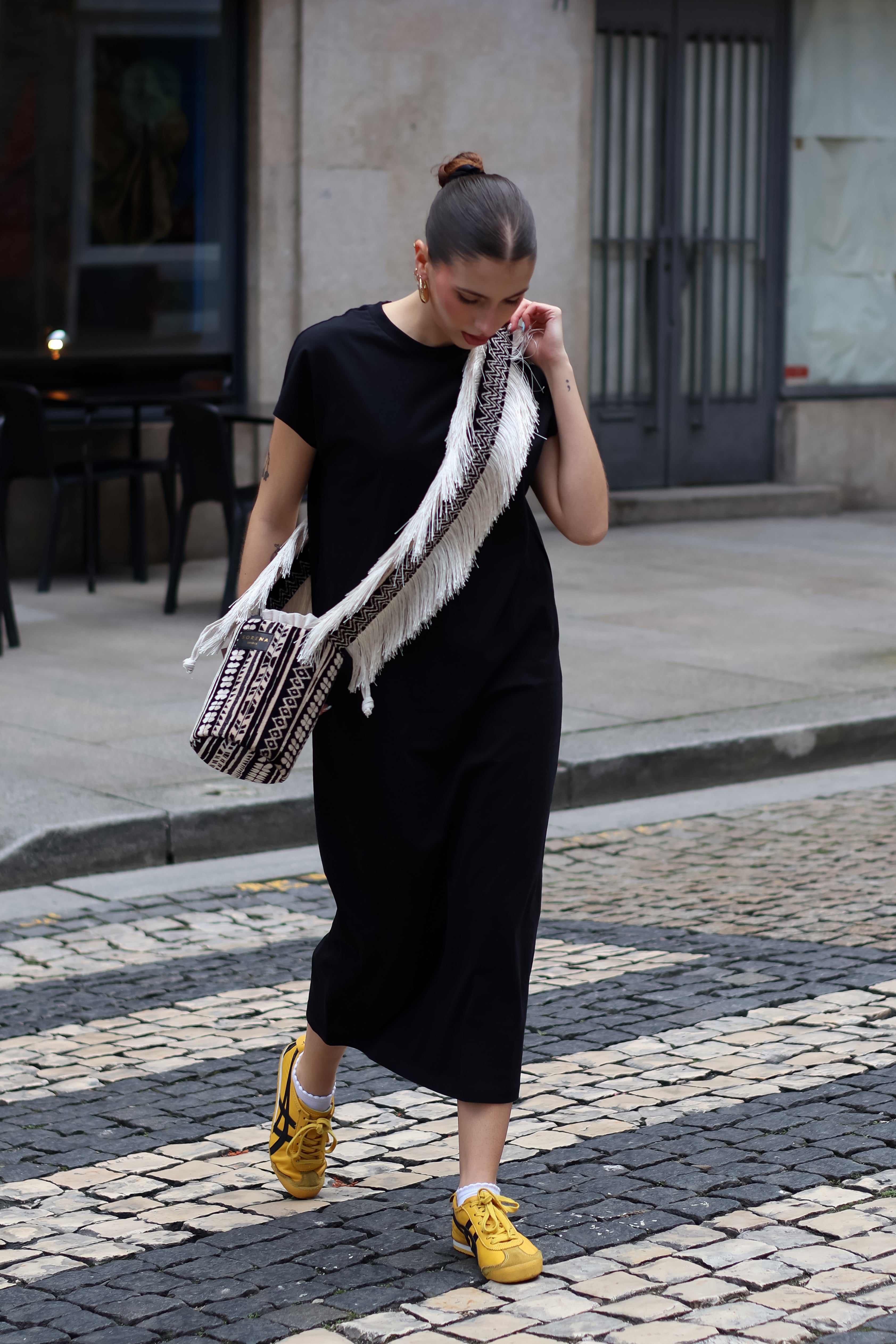 Fashion-forward black cap sleeve maxi dress with minimalist silhouette and effortless urban styling.