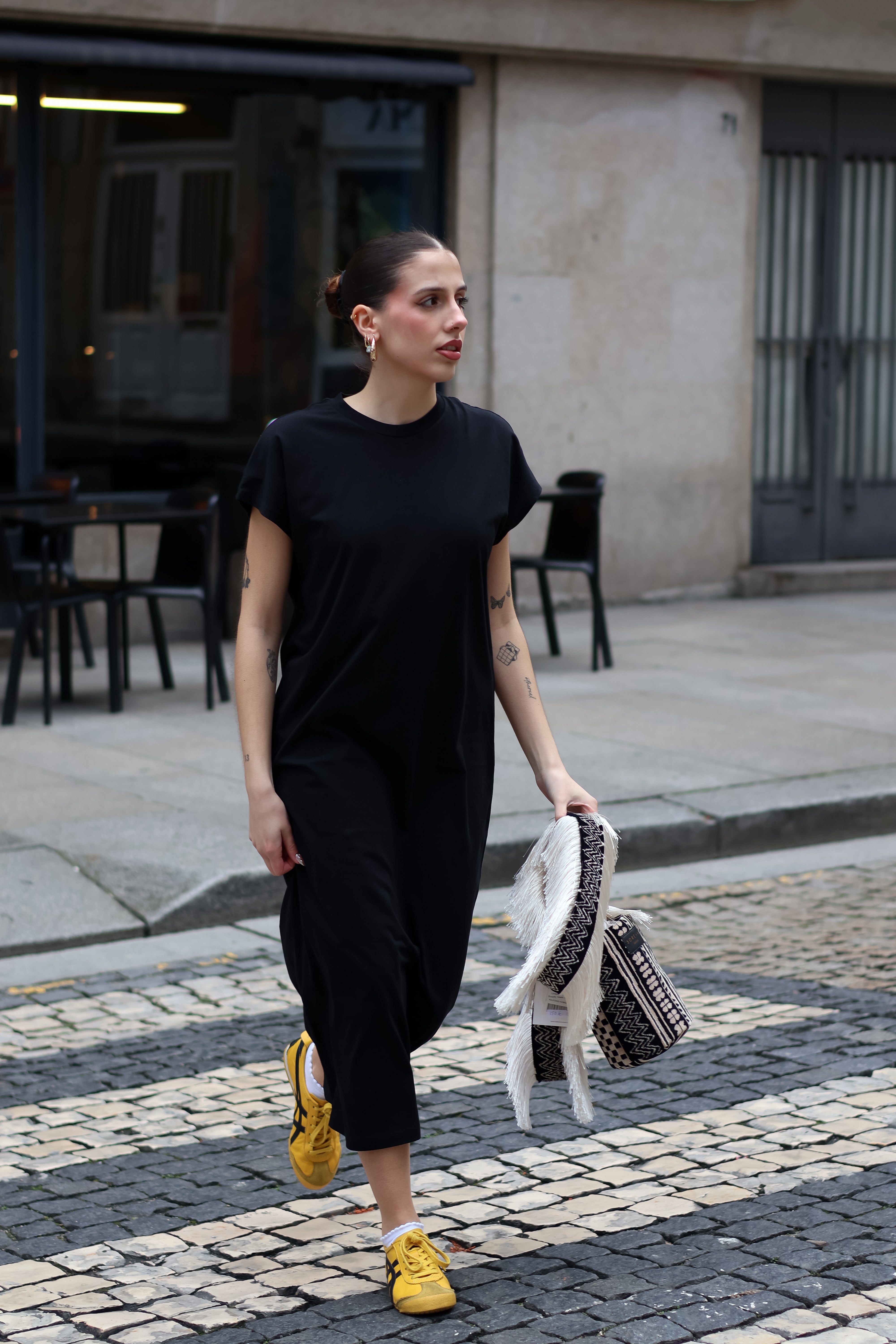 Women’s minimalist black maxi dress with relaxed drape and chic off-duty model style appeal.