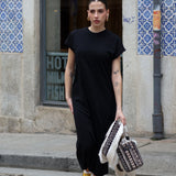 Chic oversized black midi dress featuring soft draped fabric and elevated casual everyday wear aesthetic.