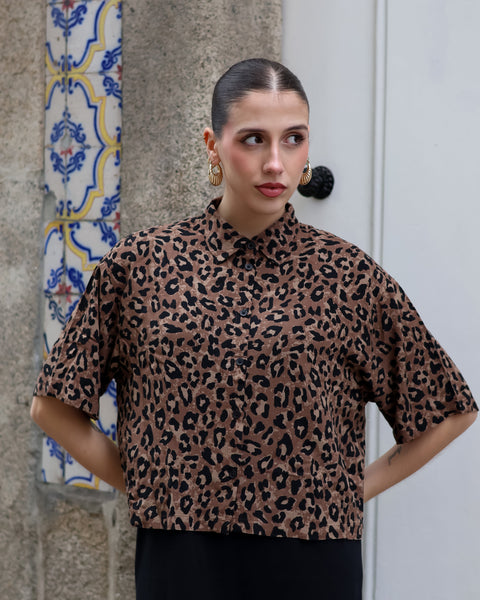 Chic animal print blouse featuring relaxed silhouette and modern safari-inspired fashion aesthetic.