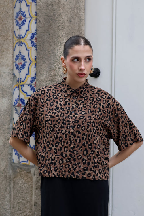 Chic animal print blouse featuring relaxed silhouette and modern safari-inspired fashion aesthetic.