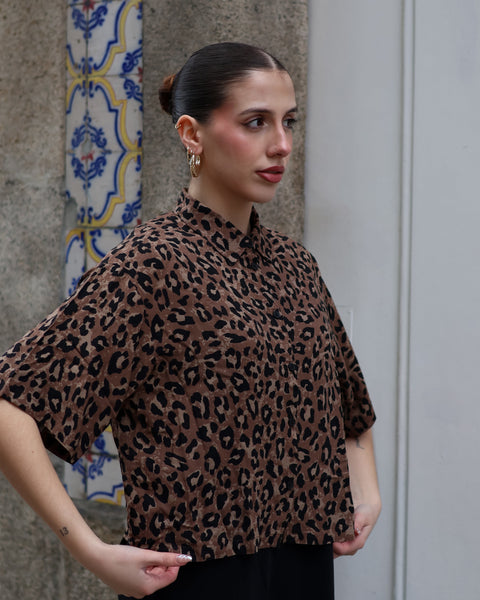 Women’s relaxed-fit leopard print button-up top with modern urban chic and statement styling.