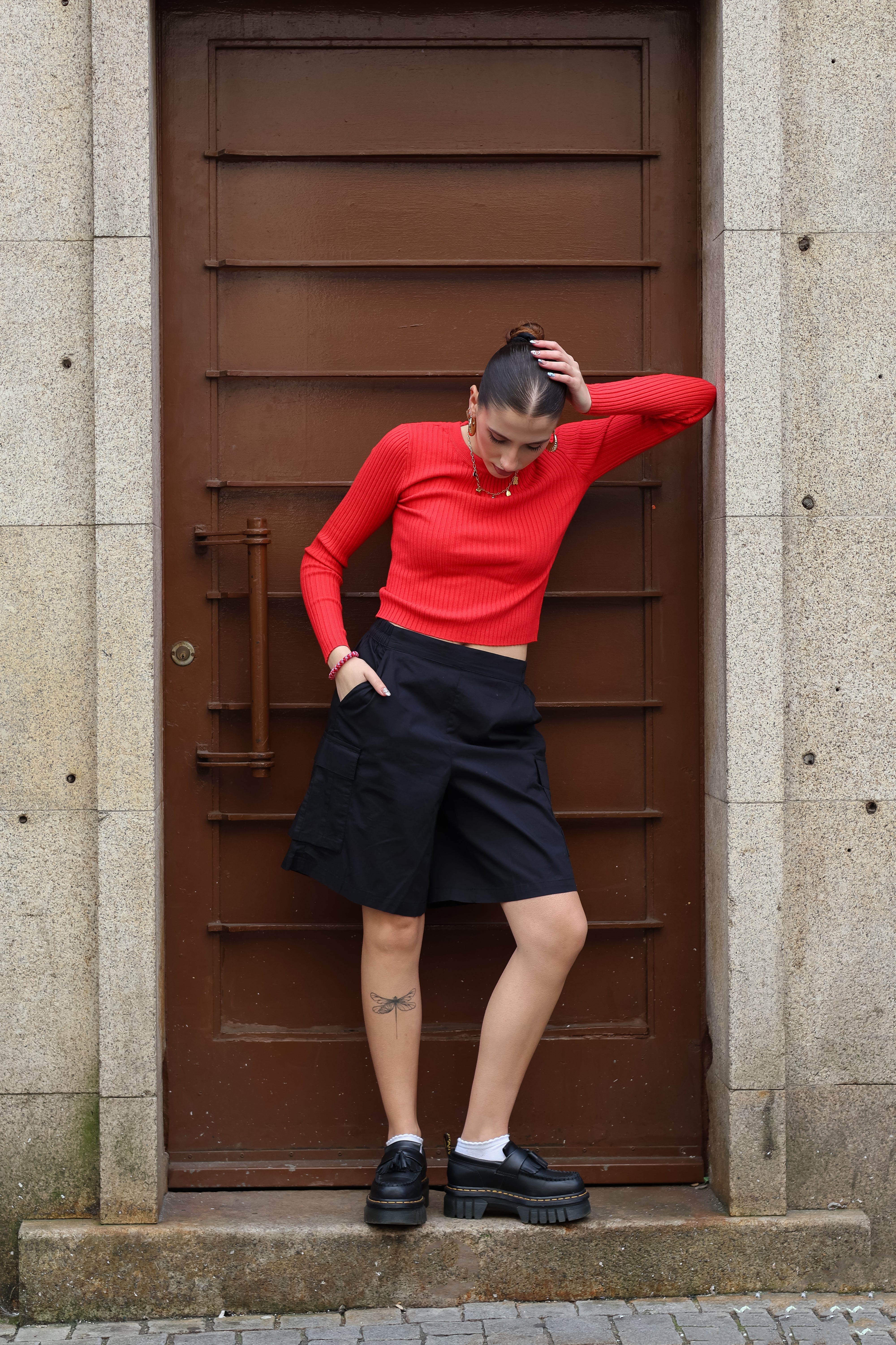 Minimalist fitted sweater in bold scarlet red with ribbed detailing and trendy off-duty fashion vibe.