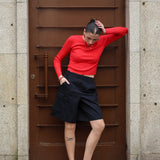 Minimalist fitted sweater in bold scarlet red with ribbed detailing and trendy off-duty fashion vibe.