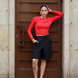 Women’s red ribbed knit crop sweater with fitted silhouette and trendy minimalist street style fashion.