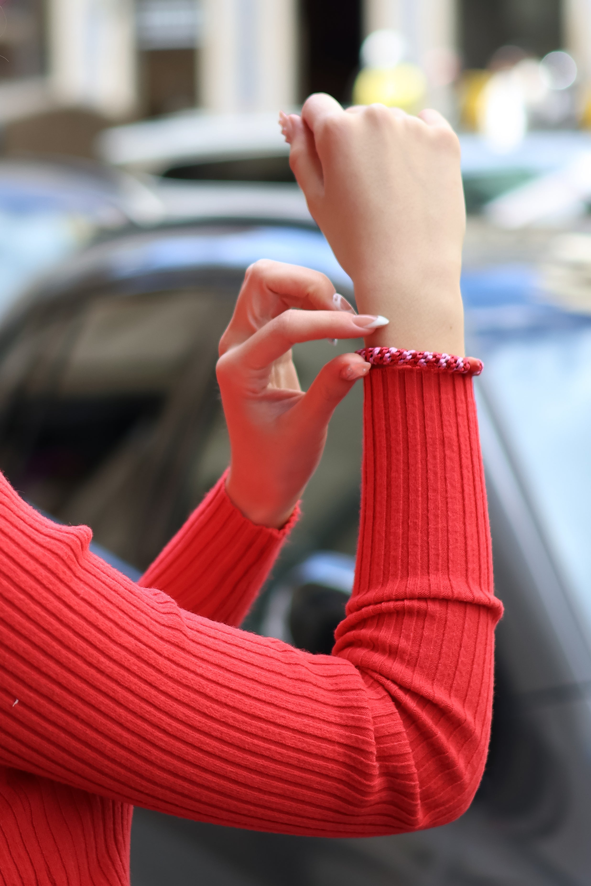 Modern slim-fit red knit pullover with long sleeves and elevated everyday fashion styling.