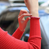 Modern slim-fit red knit pullover with long sleeves and elevated everyday fashion styling.