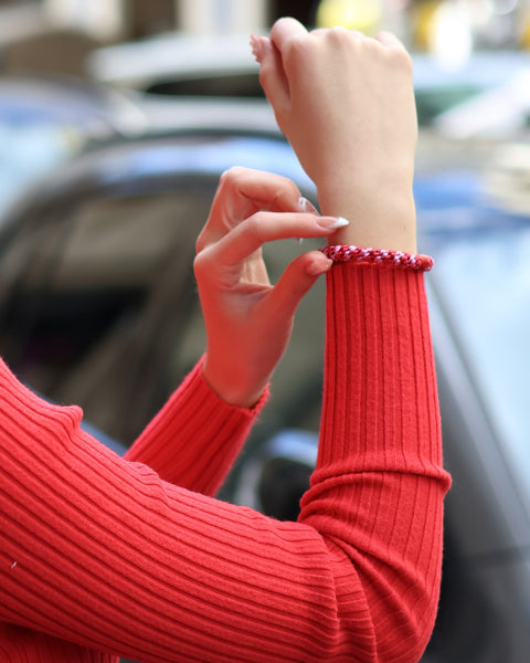 Modern slim-fit red knit pullover with long sleeves and elevated everyday fashion styling.