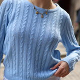 Cozy oversized cable knit sweater in soft sky blue with timeless preppy fashion aesthetic.