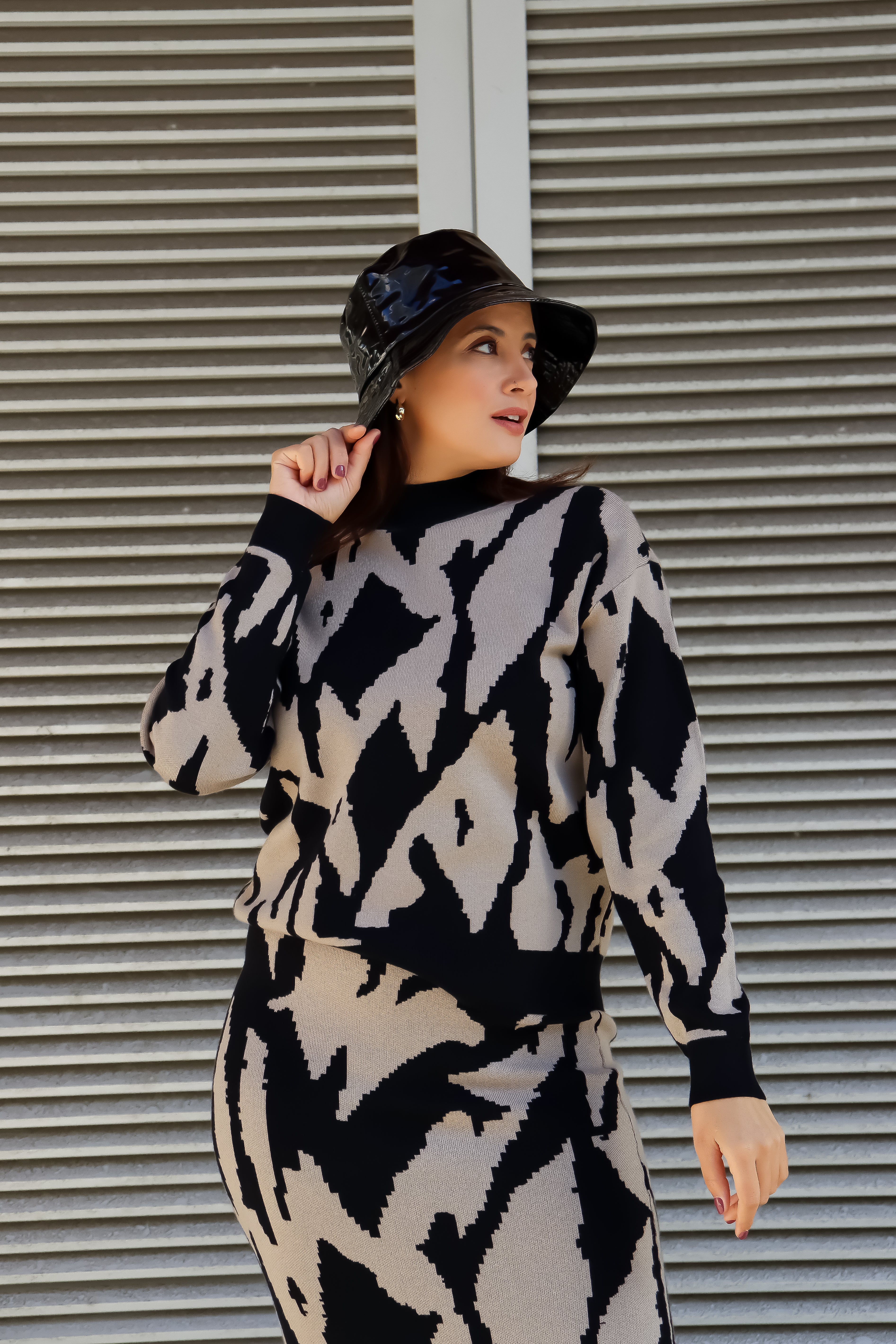 Stylish black rain bucket hat with glossy finish and modern lightweight designer-inspired fashion look.