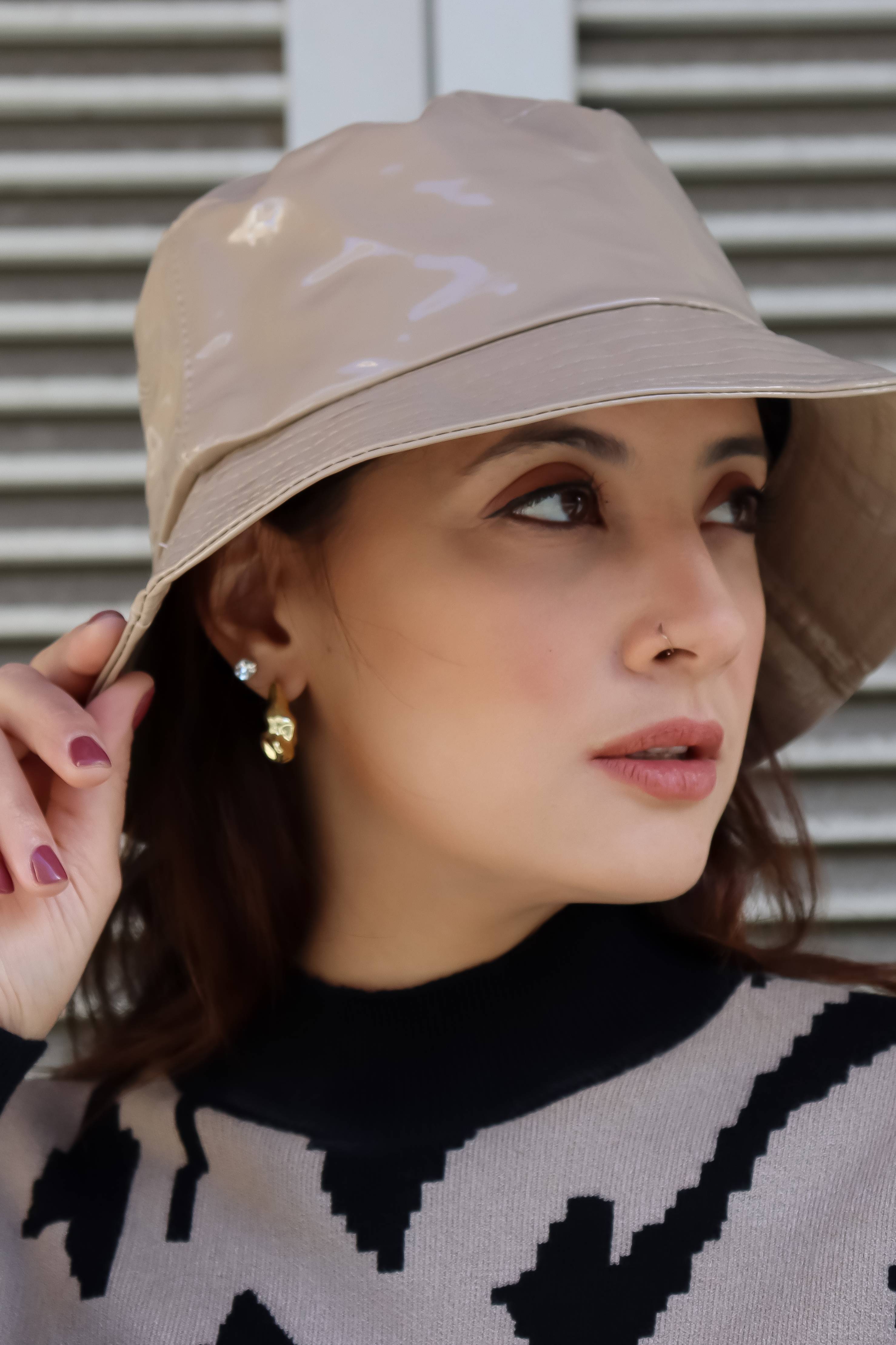 Trendy women’s nude rain hat with sleek bucket silhouette and elevated contemporary accessory styling.