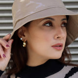 Trendy women’s nude rain hat with sleek bucket silhouette and elevated contemporary accessory styling.
