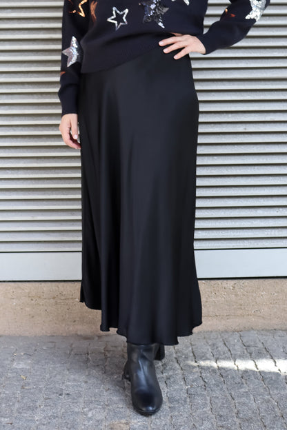 Boutique-style satin blue skirt featuring a flowing silhouette and elevated everyday day-to-night wear luxury-inspired fashion.