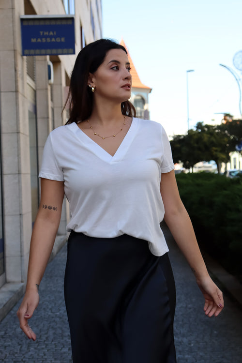 Classic white V-neck tee for women featuring a relaxed silhouette and versatile casual-chic wardrobe styling.