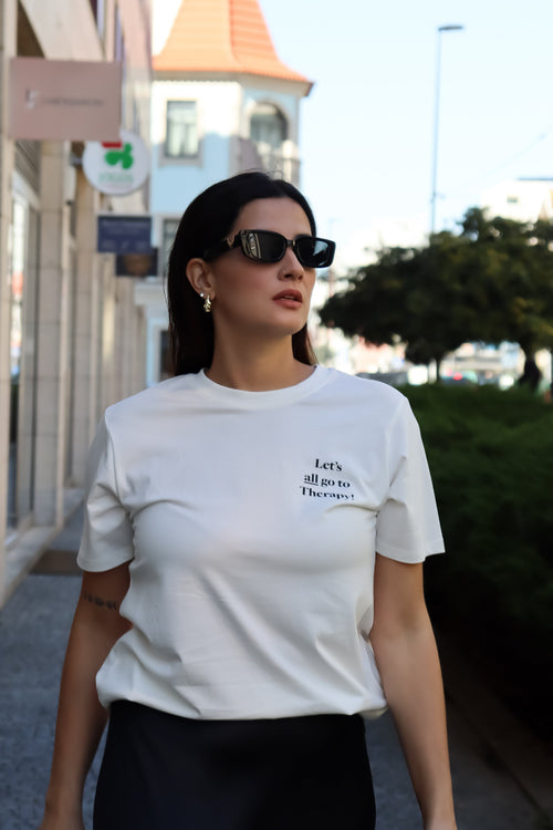 Modern graphic print T-shirt with oversized fit and minimalist black-and-white typography "Let's All Go To Therapy streetwear design.