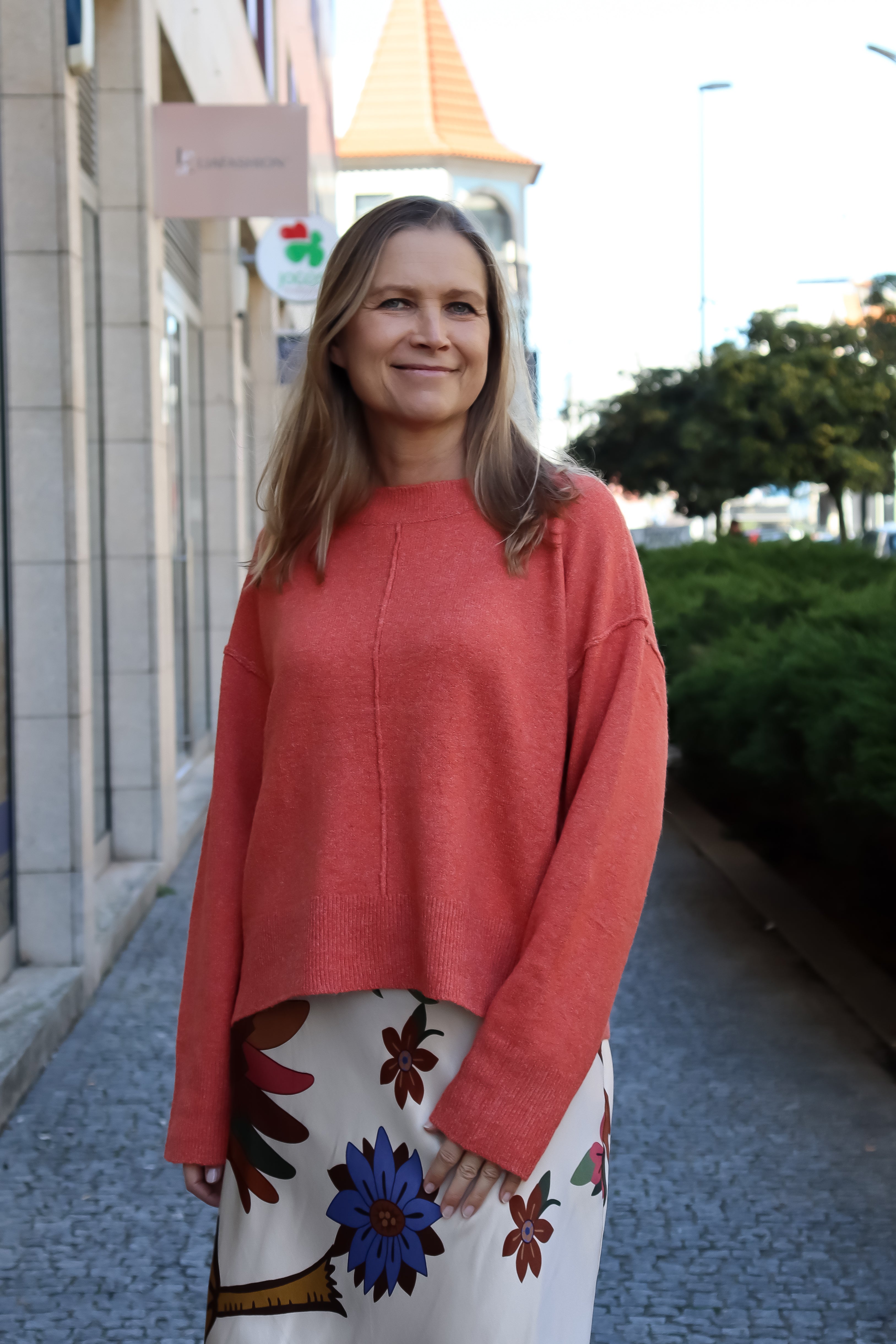 Women’s relaxed-fit salmon-colored sweater with modern silhouette and soft luxe knit texture for everyday wear.