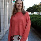 Women’s relaxed-fit salmon-colored sweater with modern silhouette and soft luxe knit texture for everyday wear.