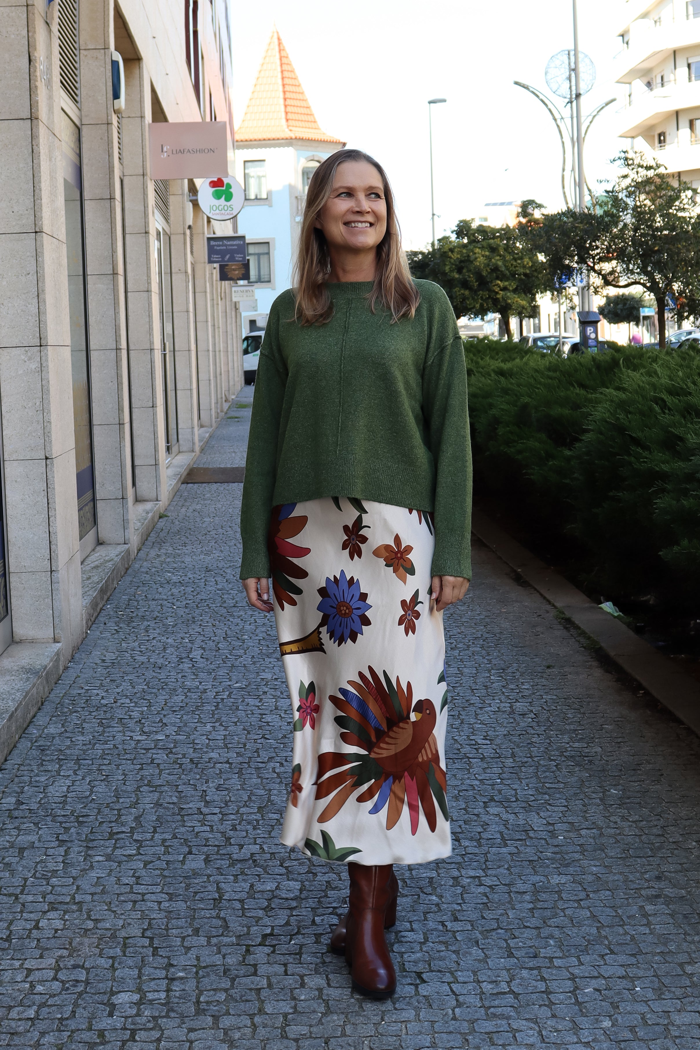 Modern emerald green sweater with cozy lightweight texture and polished contemporary fashion aesthetic.
