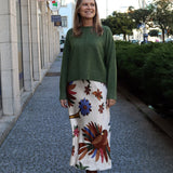 Modern emerald green sweater with cozy lightweight texture and polished contemporary fashion aesthetic.