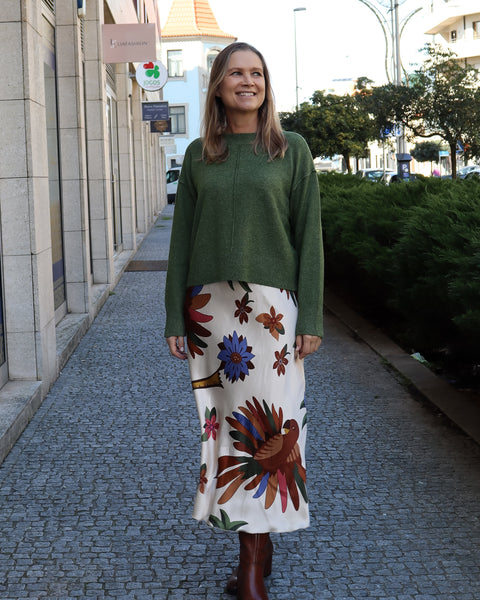Modern emerald green sweater with cozy lightweight texture and polished contemporary fashion aesthetic.