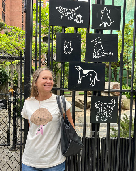 Women’s white graphic T-shirt with cute dog print and rolled short sleeves for casual everyday outfits and pet lover fashion.