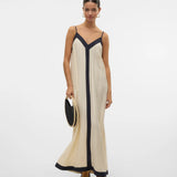 Chic flowy resort dress with contrast trim and elevated European-inspired boutique styling.