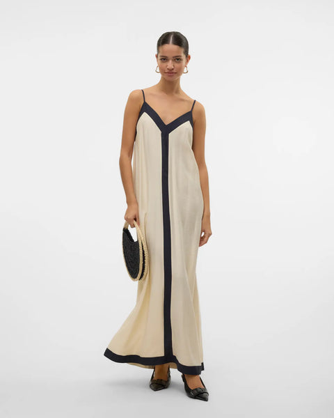 Chic flowy resort dress with contrast trim and elevated European-inspired boutique styling.