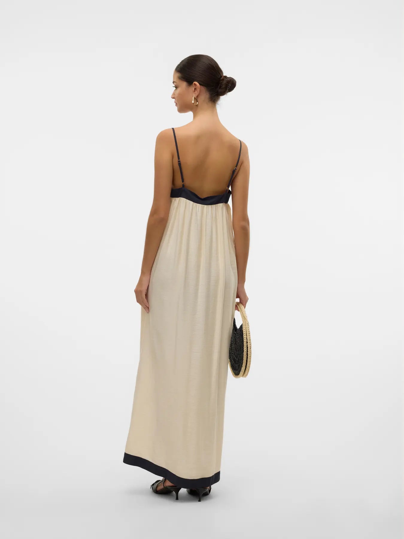 Elegant back view of women’s minimalist resortwear maxi dress with elegant contrast borders and timeless silhouette.