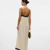 Elegant back view of women’s minimalist resortwear maxi dress with elegant contrast borders and timeless silhouette.