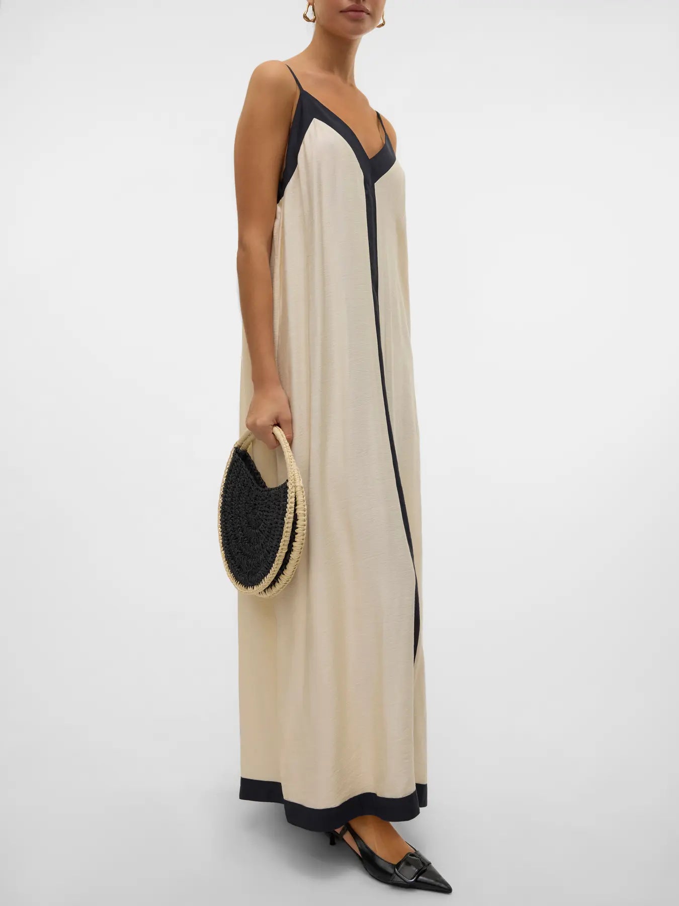 Luxe vacation-ready slip dress with modern black detailing and refined beach-to-dinner versatility.