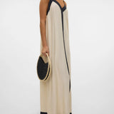 Luxe vacation-ready slip dress with modern black detailing and refined beach-to-dinner versatility.