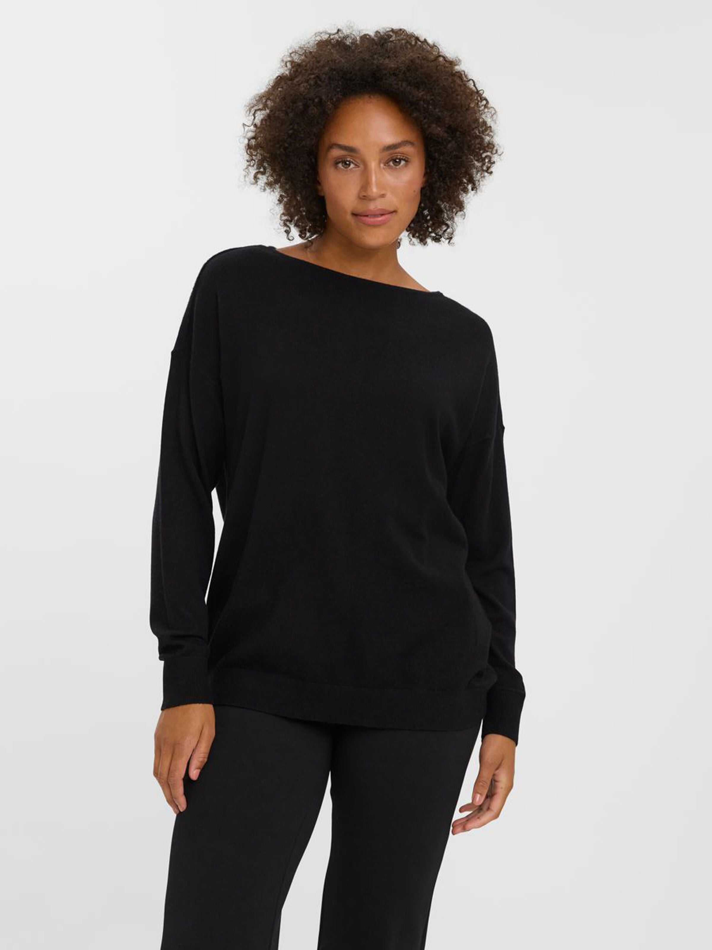 Relaxed fit black knit sweater perfect for layering with jeans, trousers, and skirts.