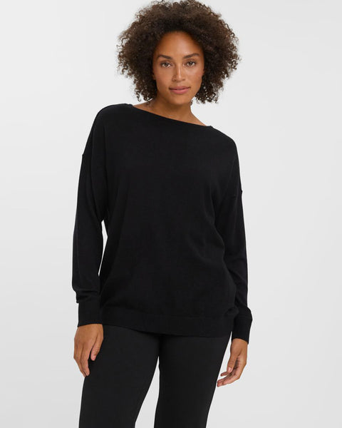 Relaxed fit black knit sweater perfect for layering with jeans, trousers, and skirts.