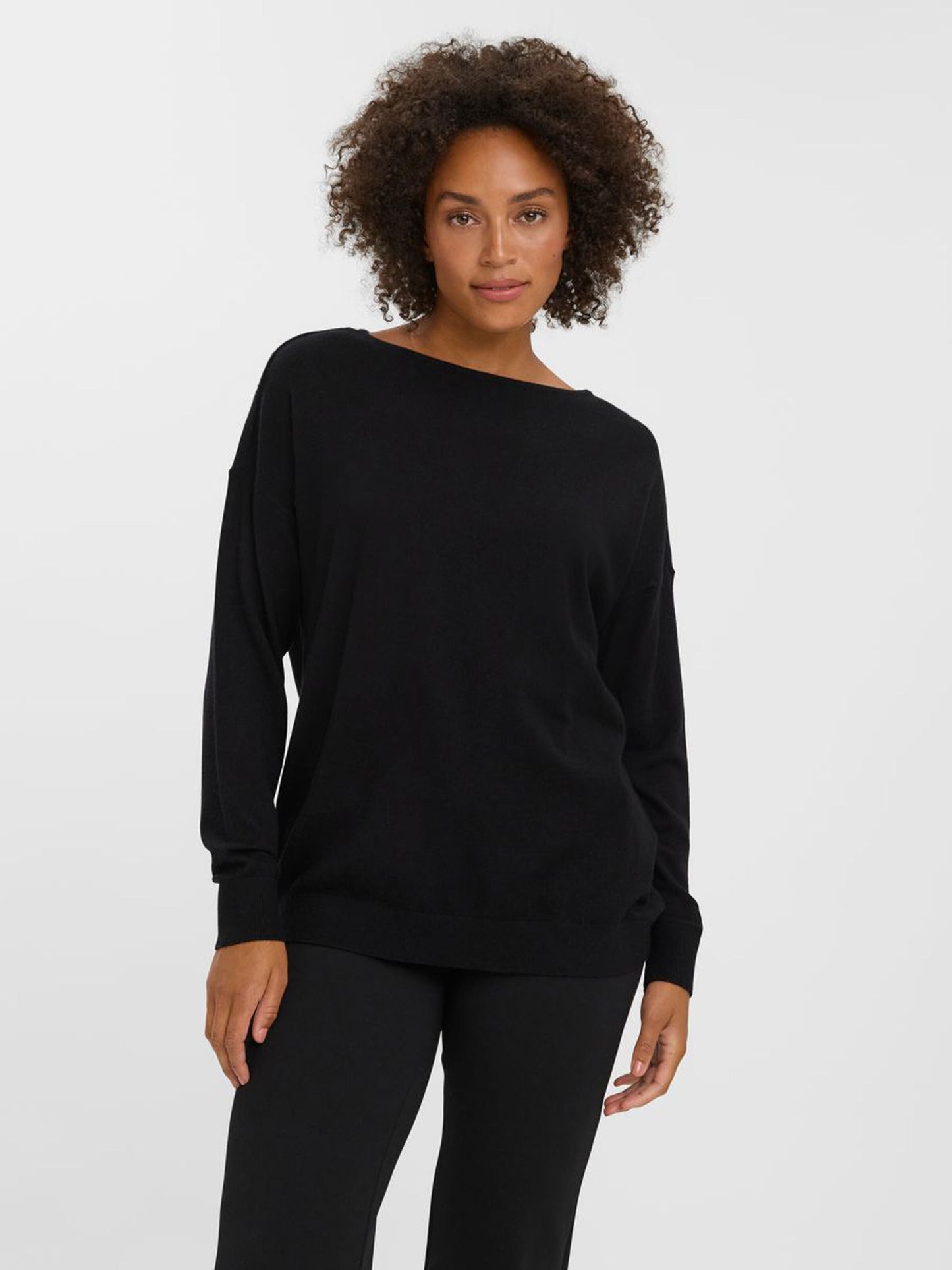 Relaxed fit black knit sweater perfect for layering with jeans, trousers, and skirts.