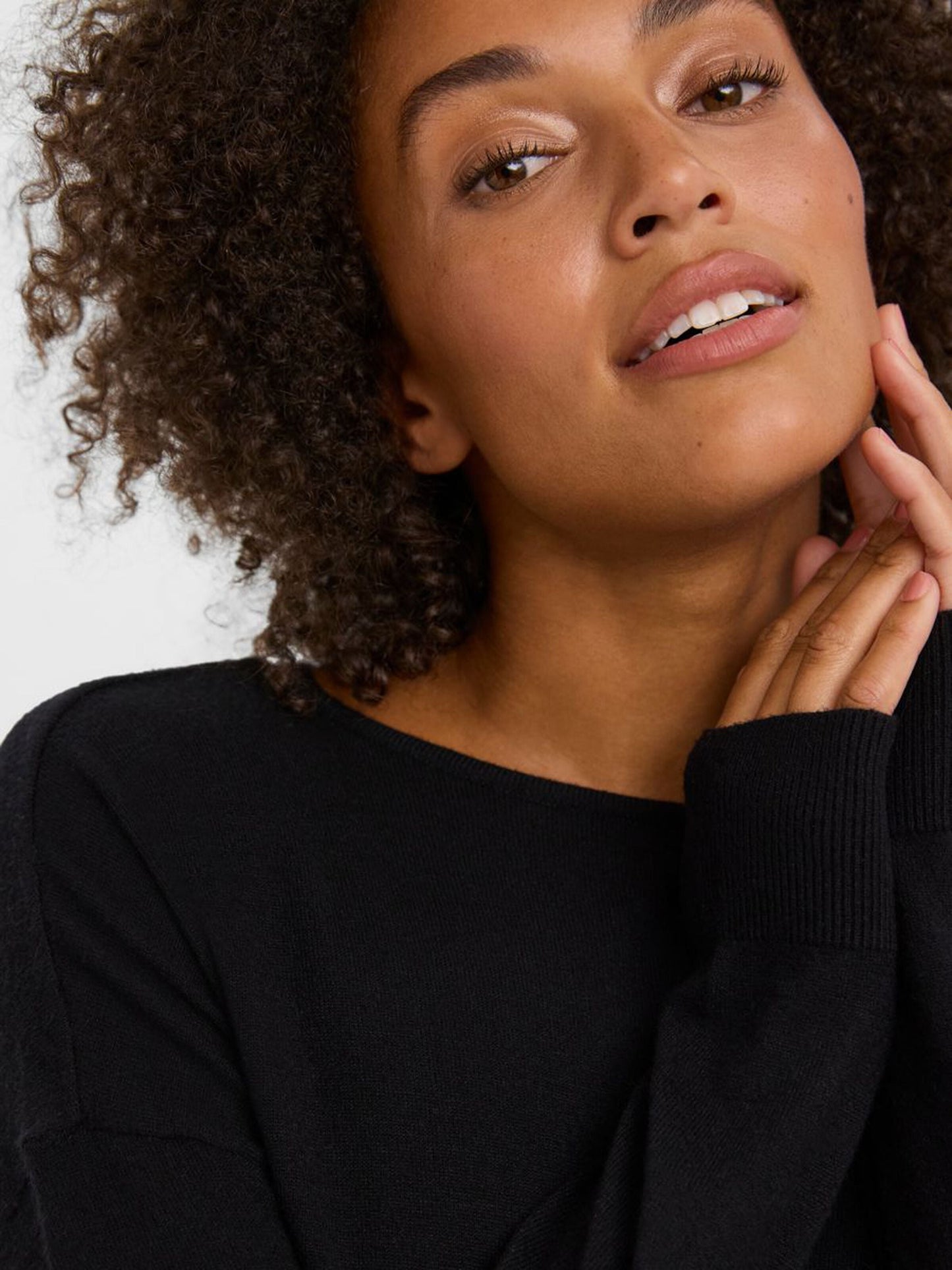 Women's versatile black knit top perfect for office looks and weekend styling.