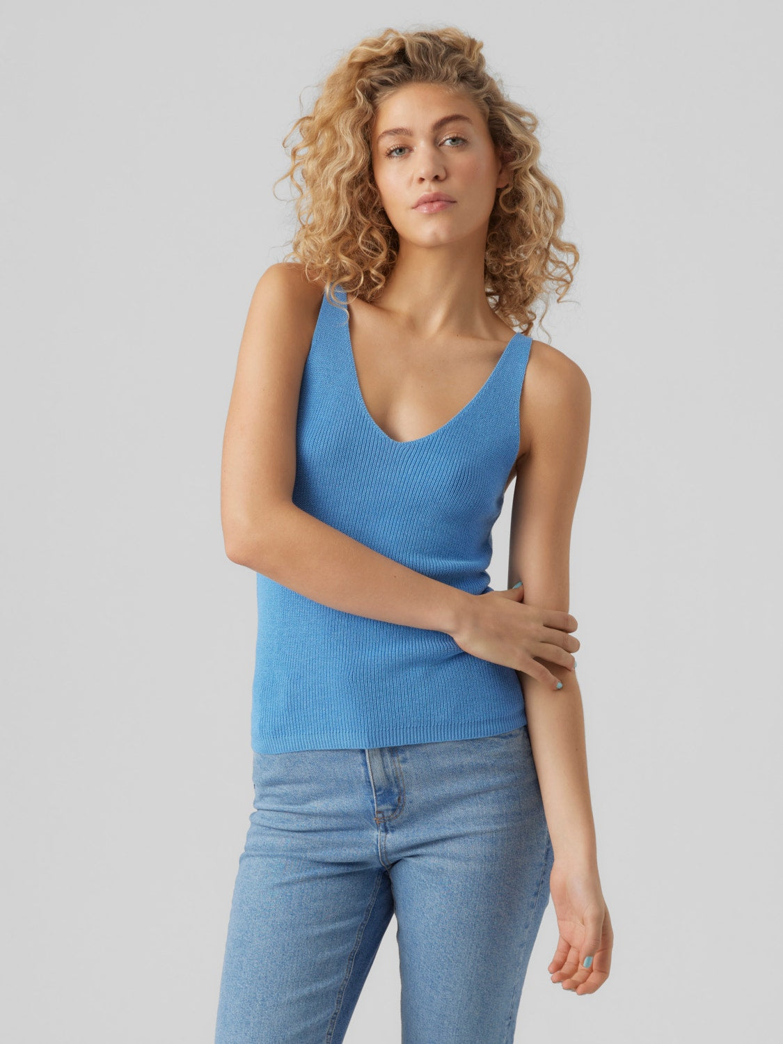 Sky blue sleeveless sweater featuring stretchy ribbed fabric and modern styling.