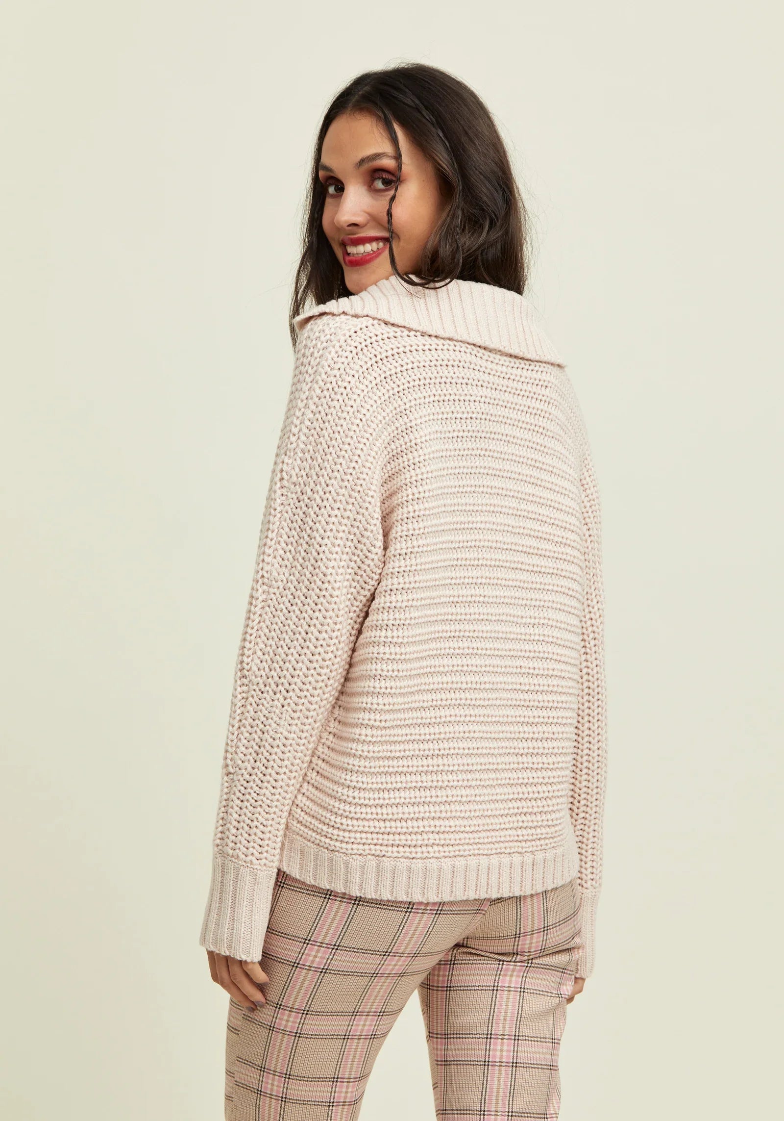 Women's cozy cream sweater featuring a modern collar and soft knitted construction.