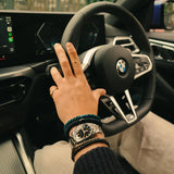 KKNEKKI Petrol. Man's hand with bracelets on a BMW steering wheel.  Kknekki's are for men too.