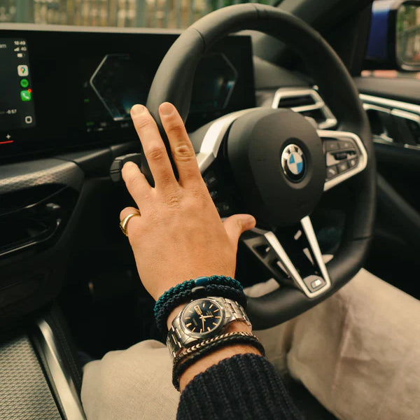 KKNEKKI Petrol. Man's hand with bracelets on a BMW steering wheel.  Kknekki's are for men too.